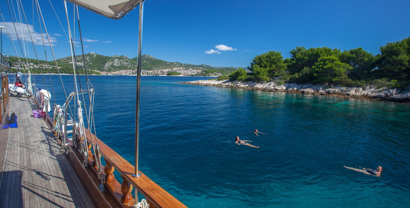 Relaxing in the waters at the side of the Stella Mari,s a 124.6’ that accommodates 16 guests 