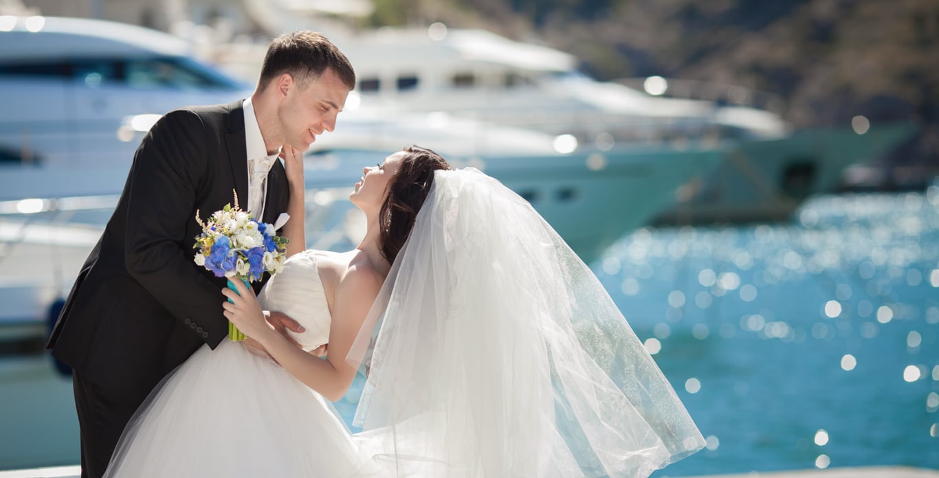 Happy wedded couple on board their luxury chartered yacht to celebrate their marriage.