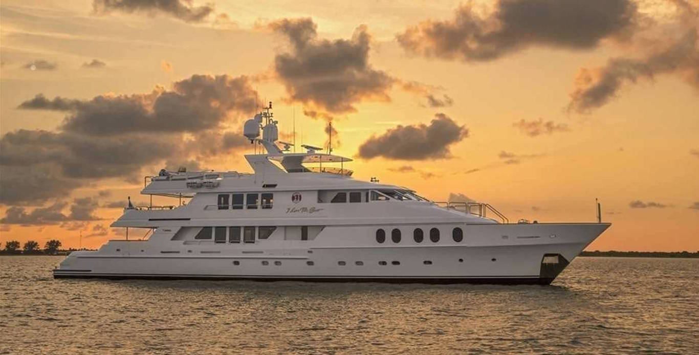 Caribbean Motor Yacht Charters anchored in harbor during sunset.