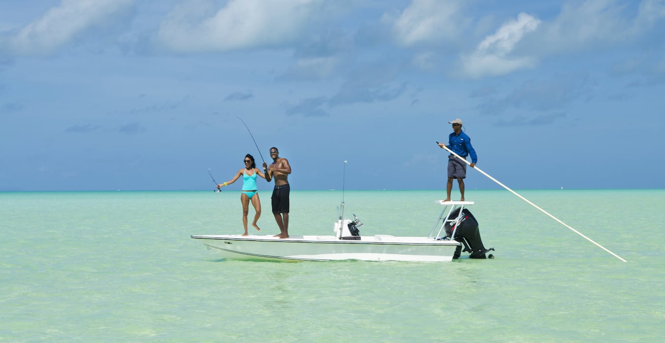 Couple bonefishing in the Anegada reef with a fishing guide.