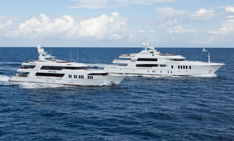 Two super yachts cruising in tandem