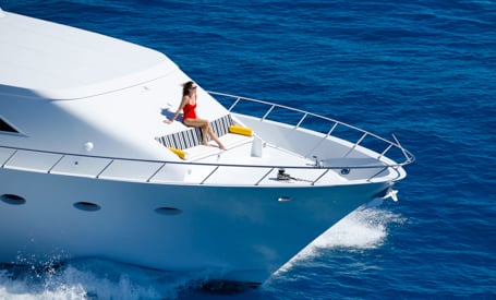 woman on bow on motor yacht charter of motor yacht