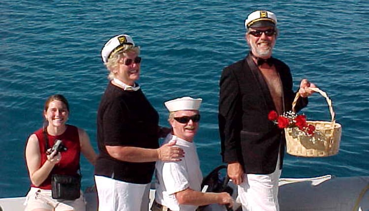 Ocean Getaways charter yacht brokers delivering roses to group