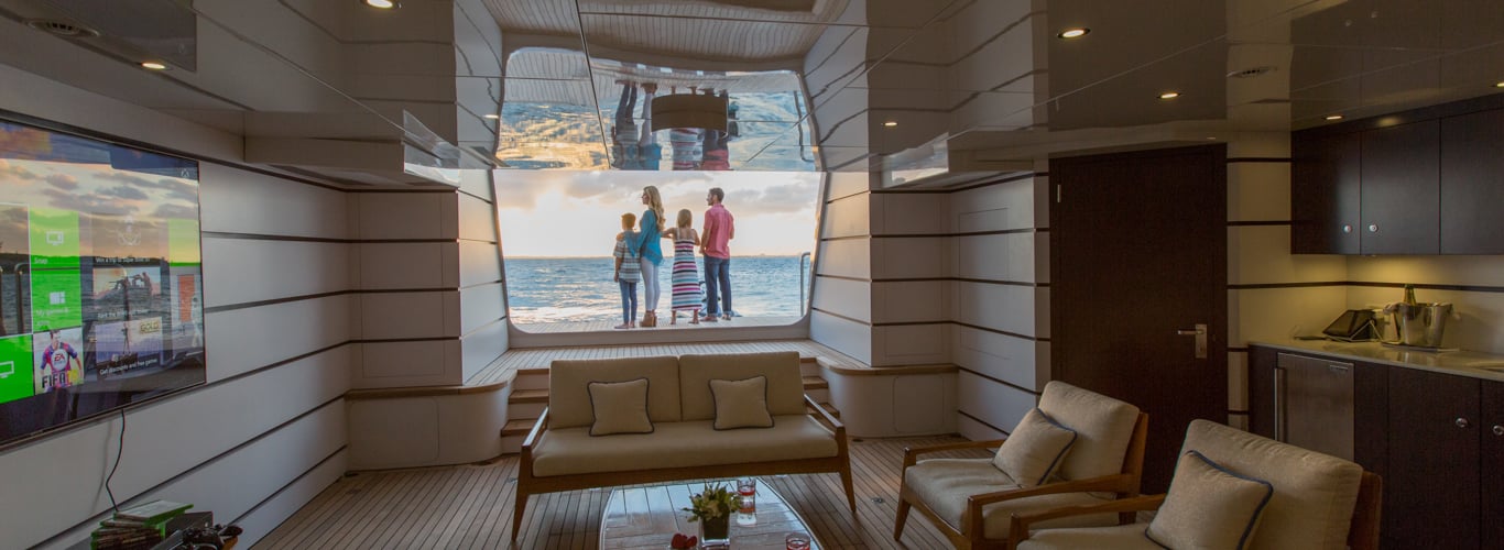 family on the beach club of a superyacht in the BVI