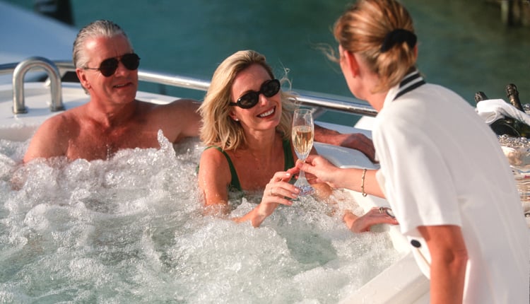 champagne toast on exclusive motor yacht charter