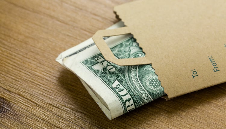 yacht charter price -Dollar bills in paper bag